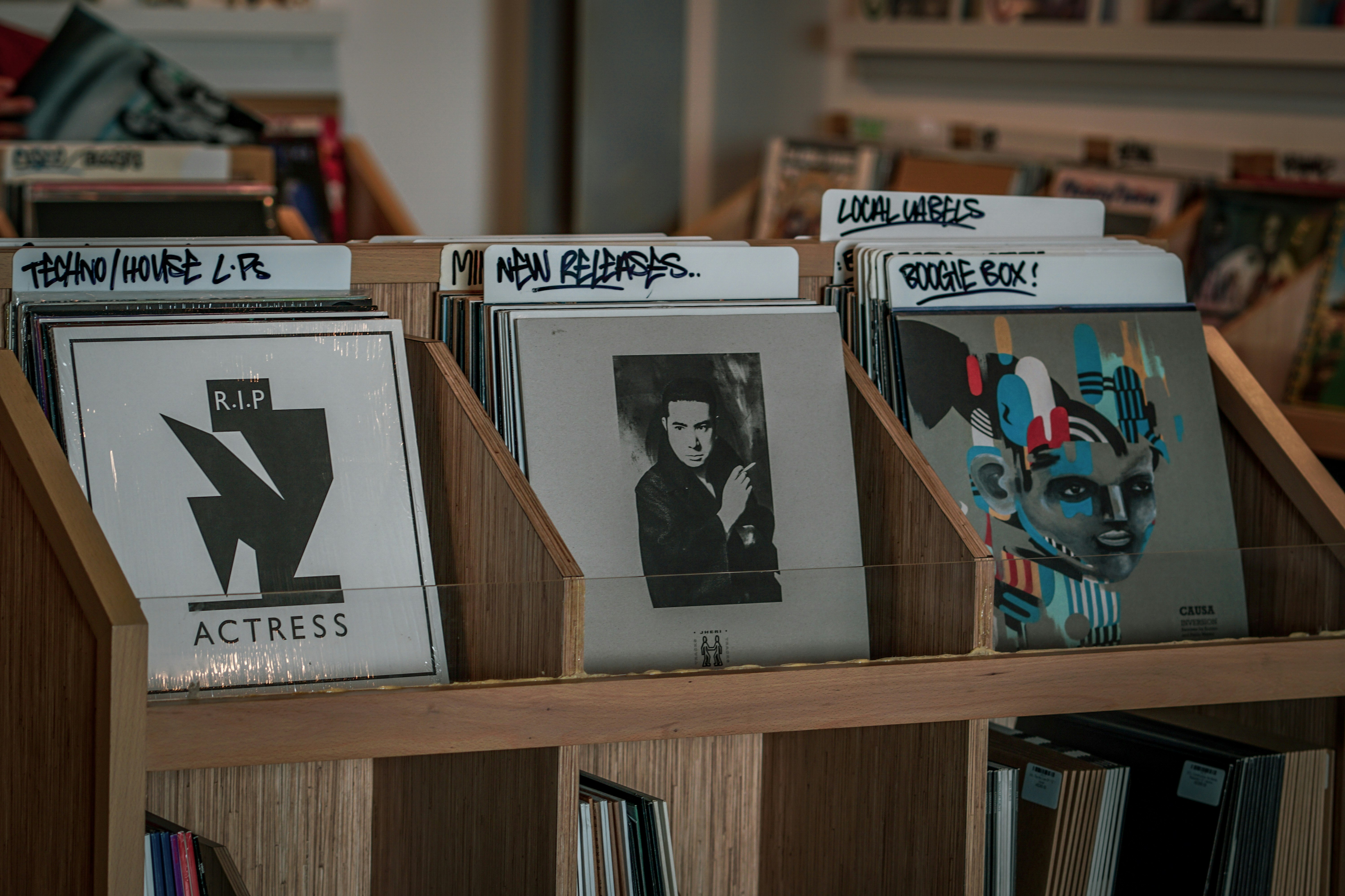 assorted albums on brown wooden rack